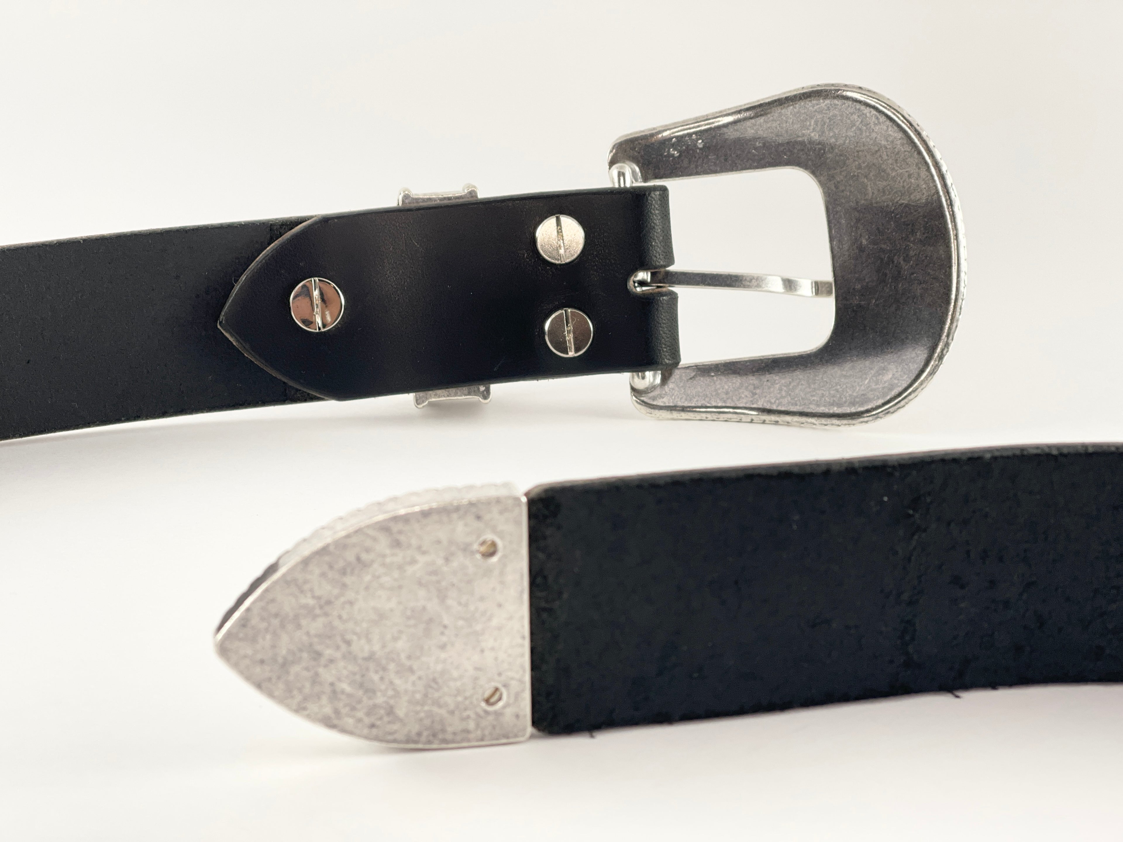 Black leather belt with silver buckle on a white background