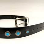 Black belt with silver buckle and turquoise conchos on a white background