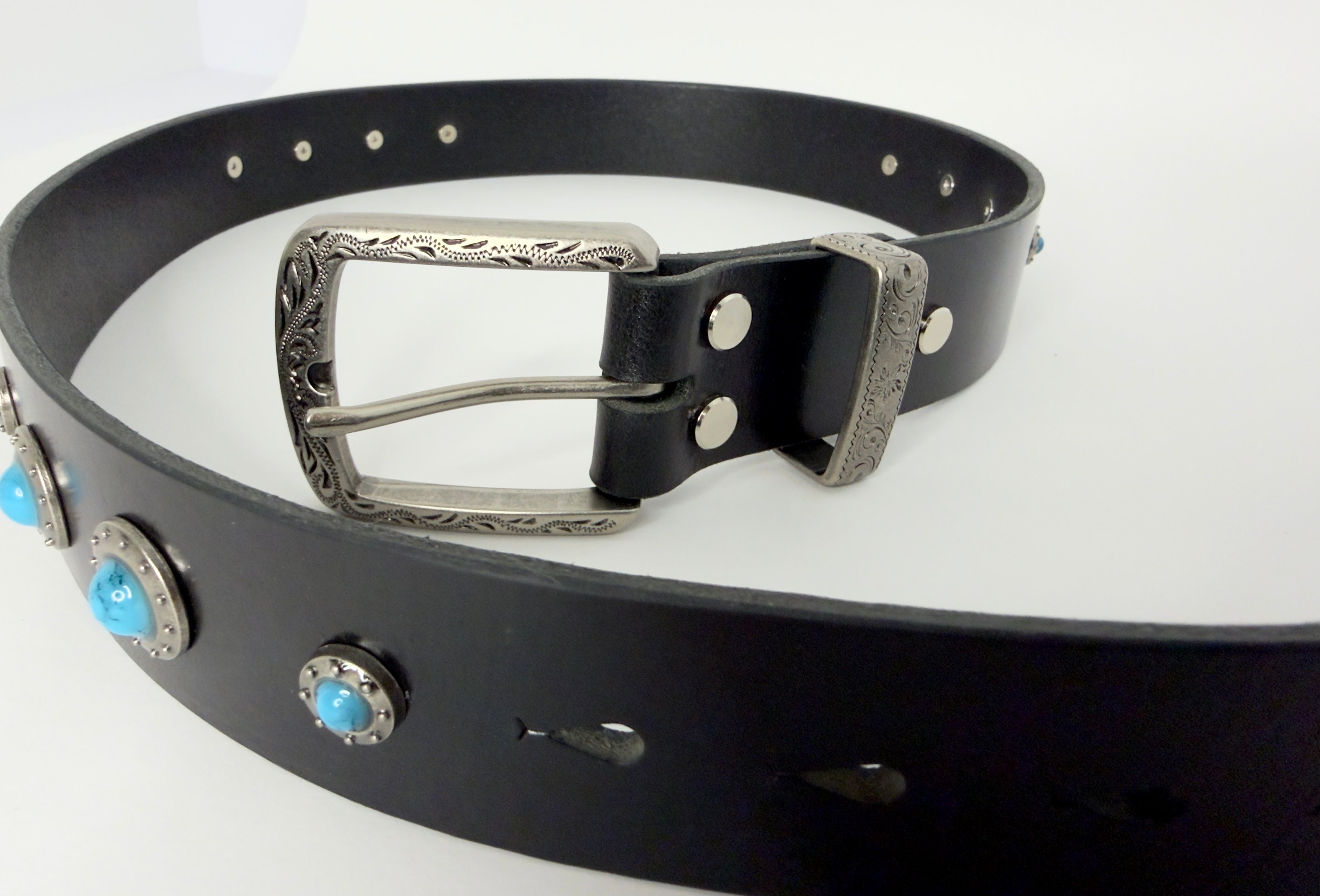 Black leather belt with silver buckle and turquoise conchos on a white background