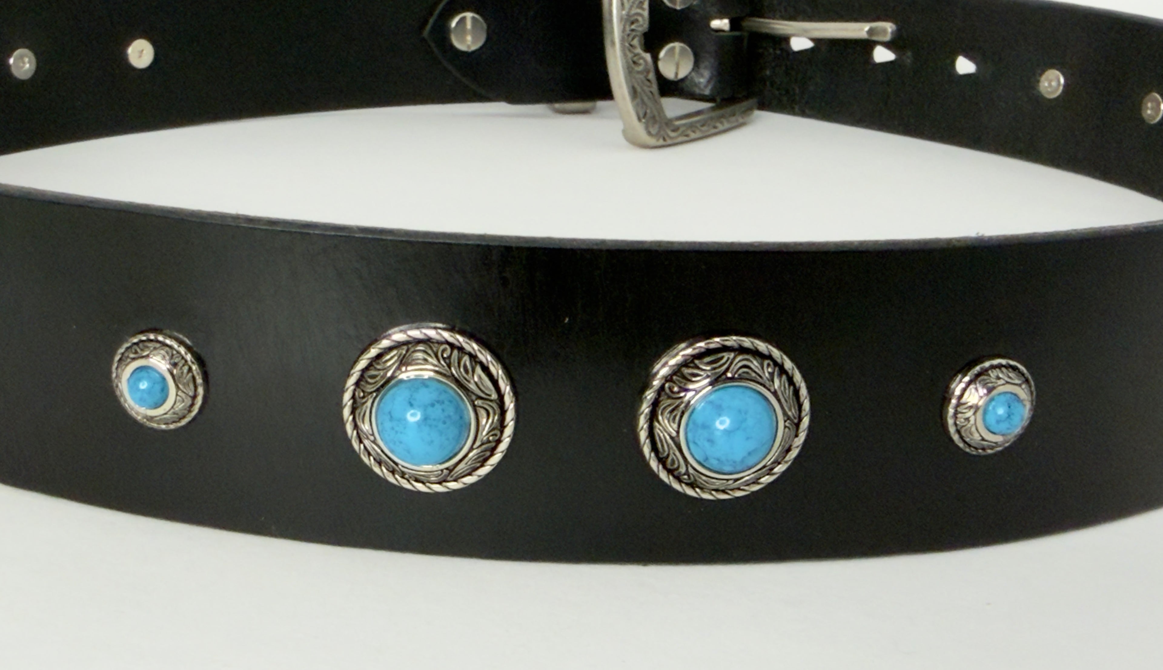 Black leather belt with silver buckle and turquoise gemstones on a white background