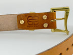 Brown leather belt with gold buckle and 'Brass Blade' branding on a white background