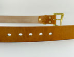 Brown leather belt with gold buckle on a white background