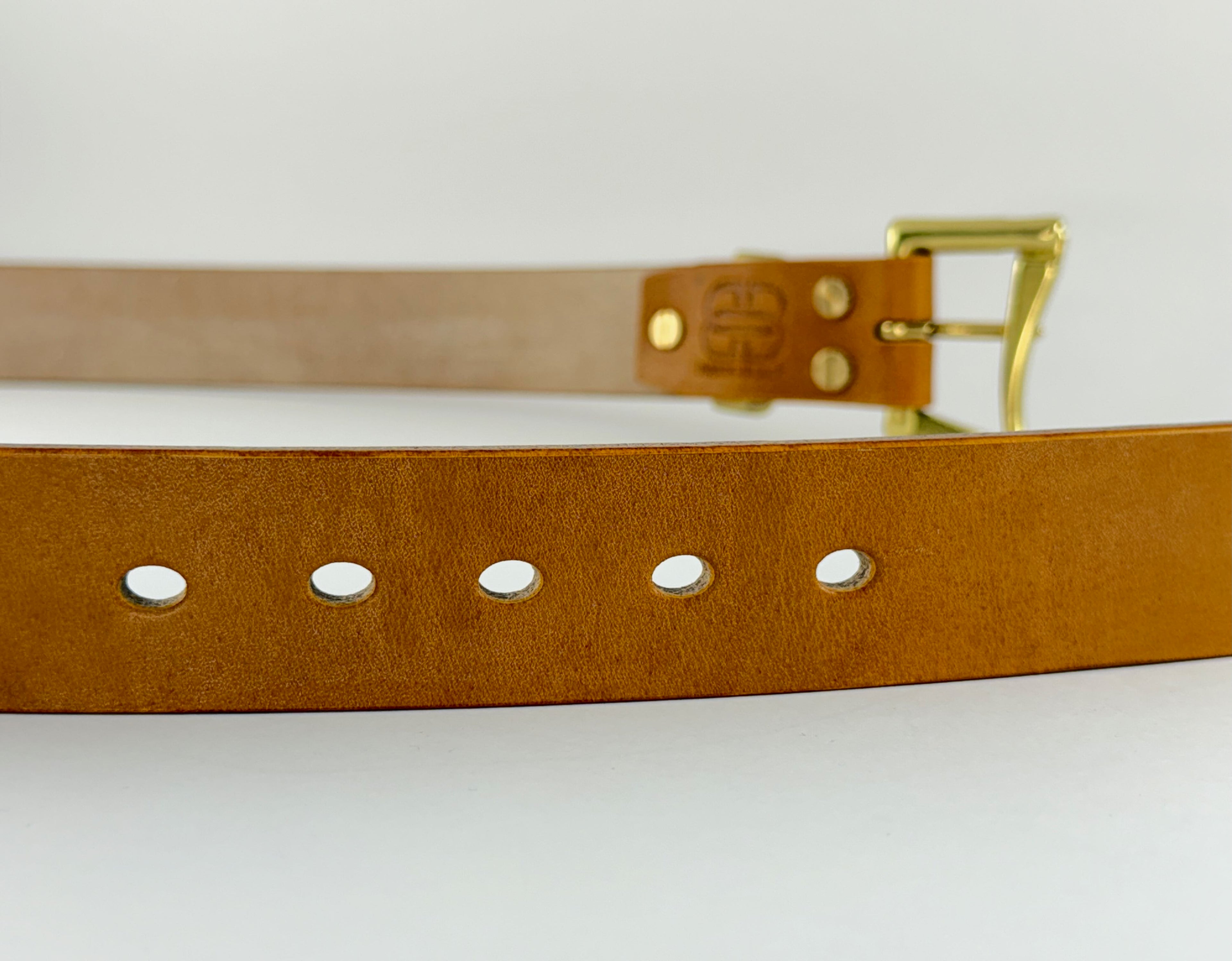 Brown leather belt with gold buckle on a white background