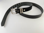 Black leather belt with silver buckle in a coiled position on a white background.