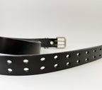 Black leather belt with closeup of belt holes on a white background