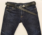 Blue jeans with a black leather belt on a grey  background