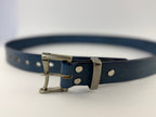 Blue leather belt with silver buckle on a light gray background