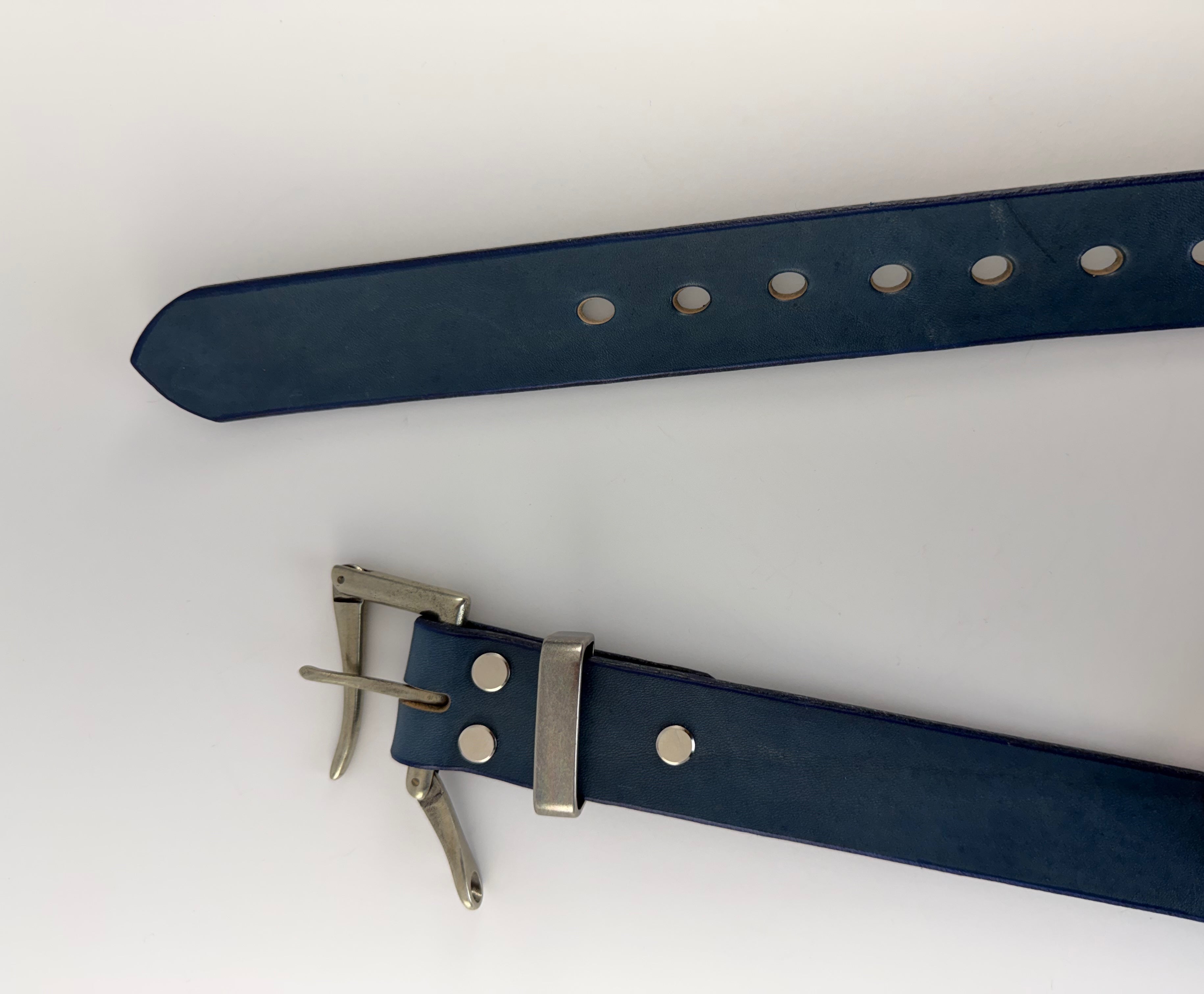 Blue leather belt with silver buckle on a white background