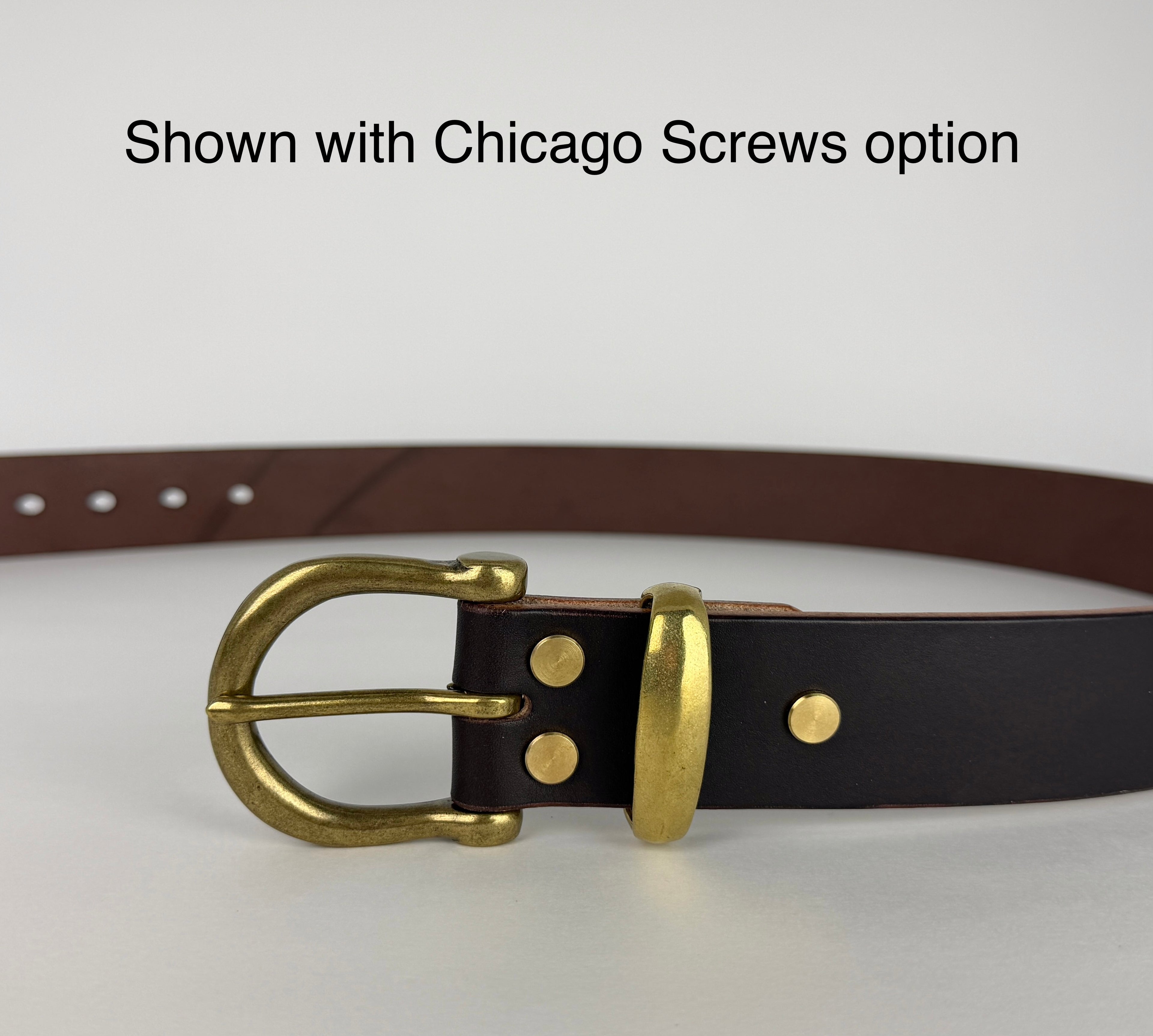 Close up picture of a brass buckle and keeper on a brown leather belt. There's a caption that says "Shown with Chicago Screws option" at the top of the screen.