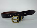 Picture of a brown leather belt on a white surface with a close up of brass buckle, keeper and rivets.