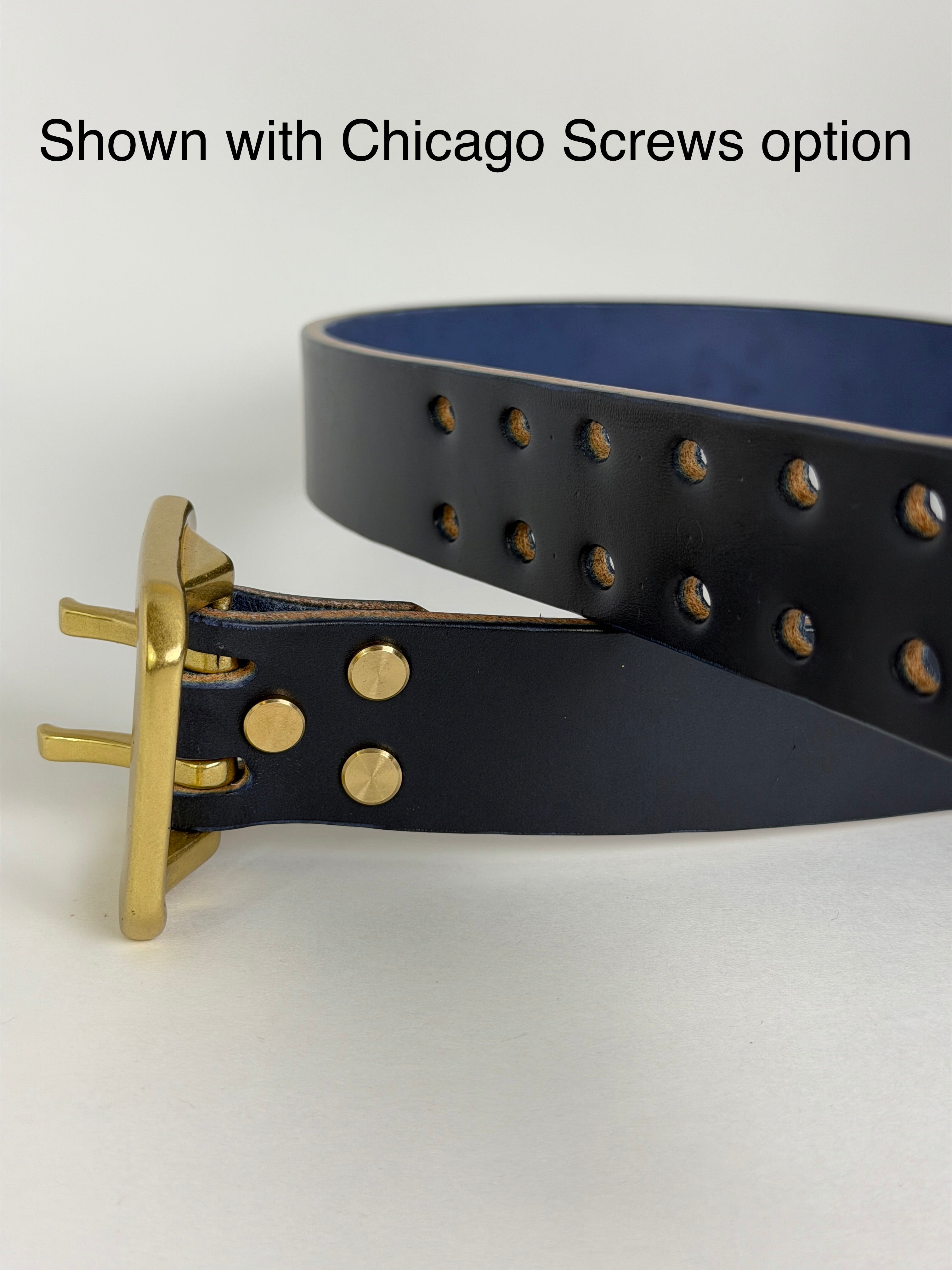 Navy leather belt with brass hardware on a white background.  The Chicago screws are being highlighted as an option and alternative to solid brass rivets.