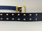 Close-up of a navy blue leather belt with double-pronged holes and a brass buckle on a white background