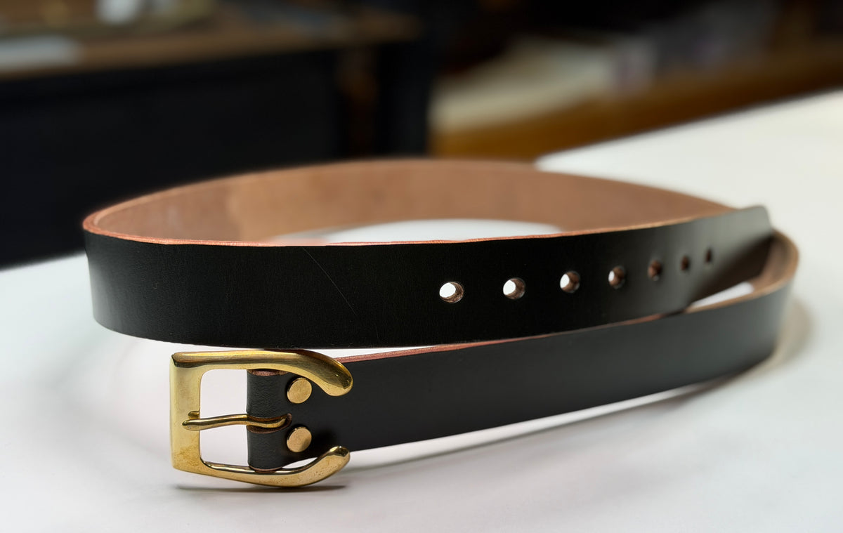 A front view of a dark green belt on a white background.  This belt is made from dark green leather, with a brass horseshoe buckle and brass Chicago screws.