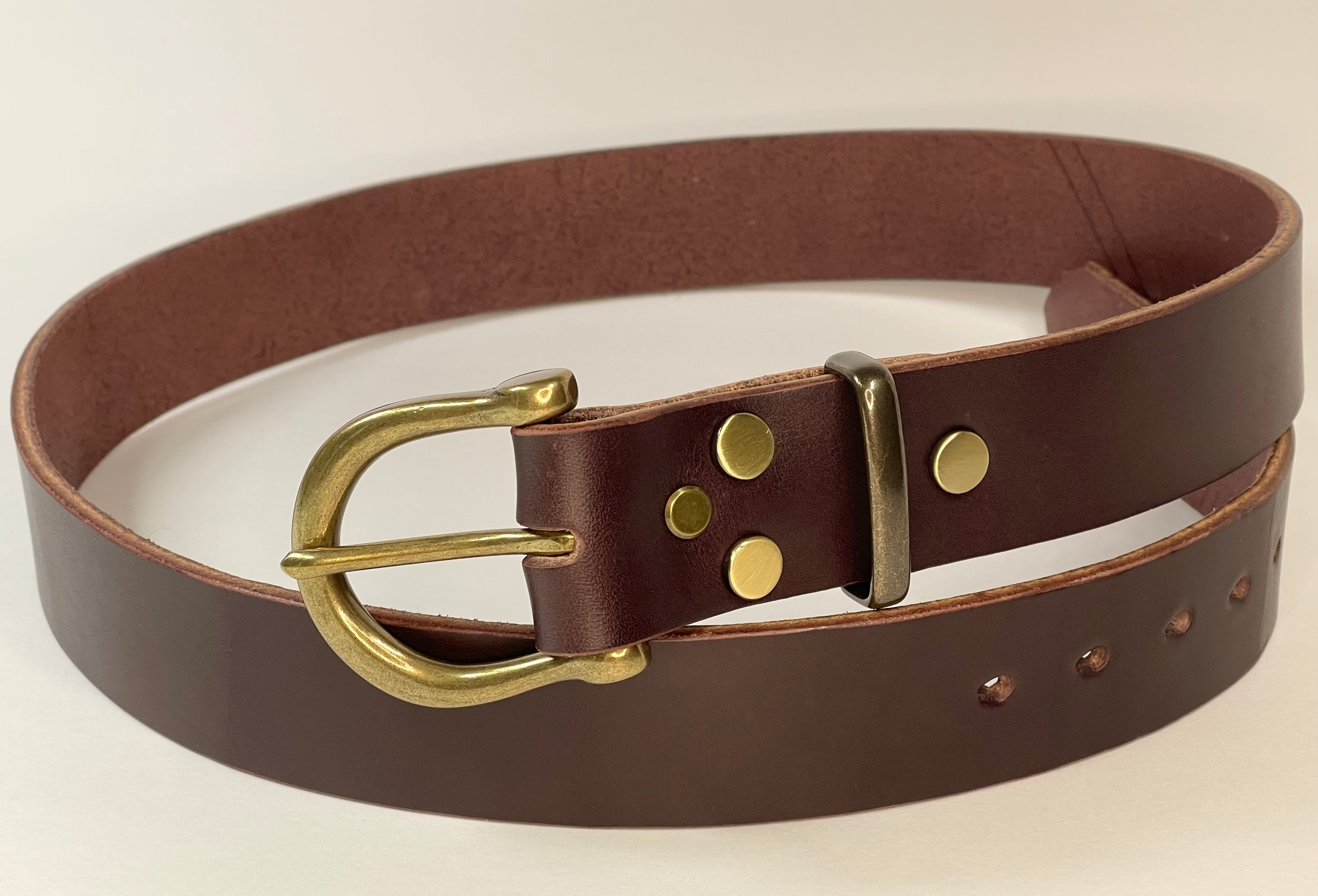 Brown leather belt with brass buckle on a white background