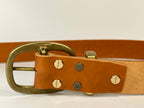 Brown leather belt with brass buckle on a white background