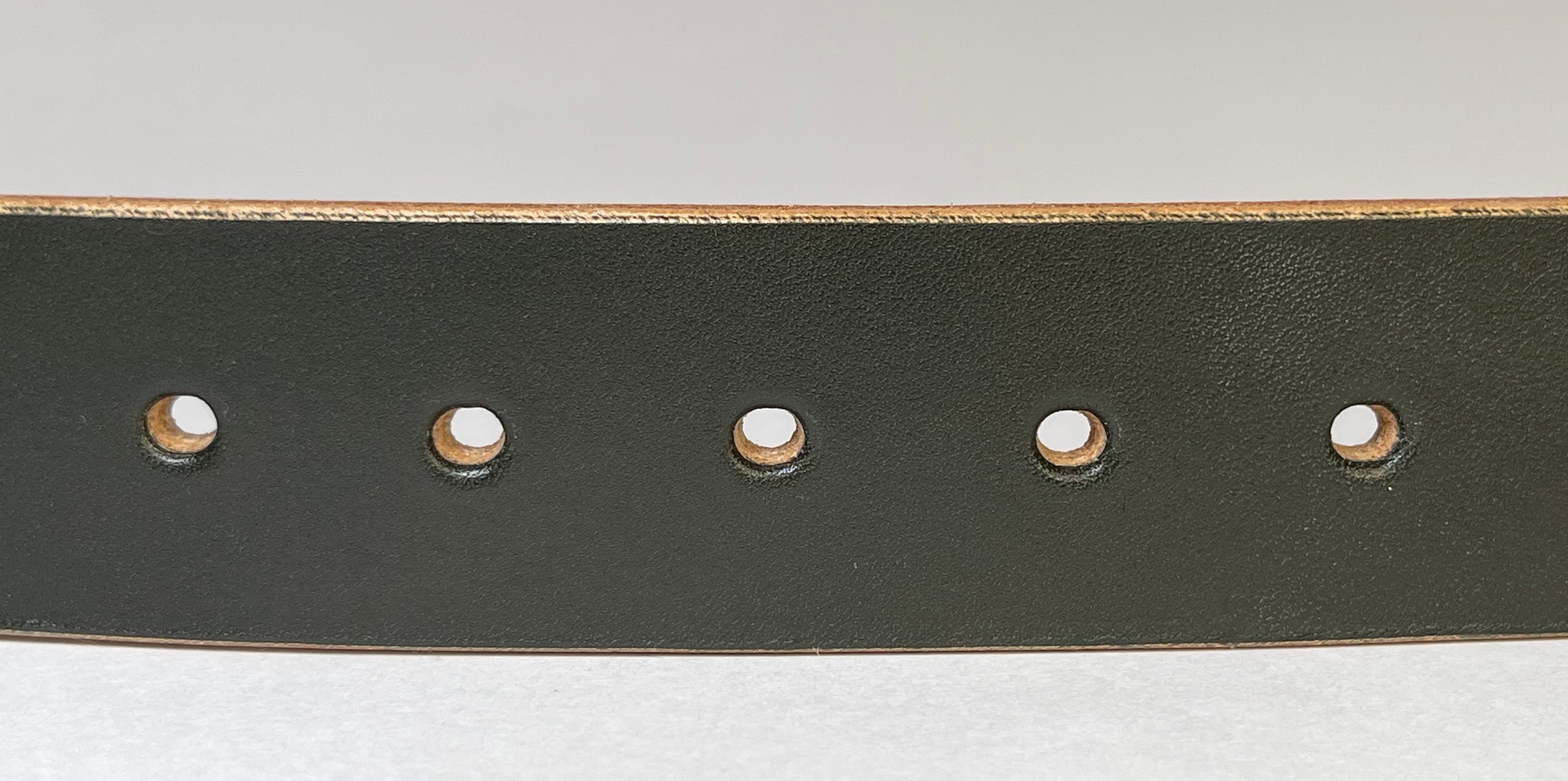 Dark green leather belt with gold buckle on a light gray background
