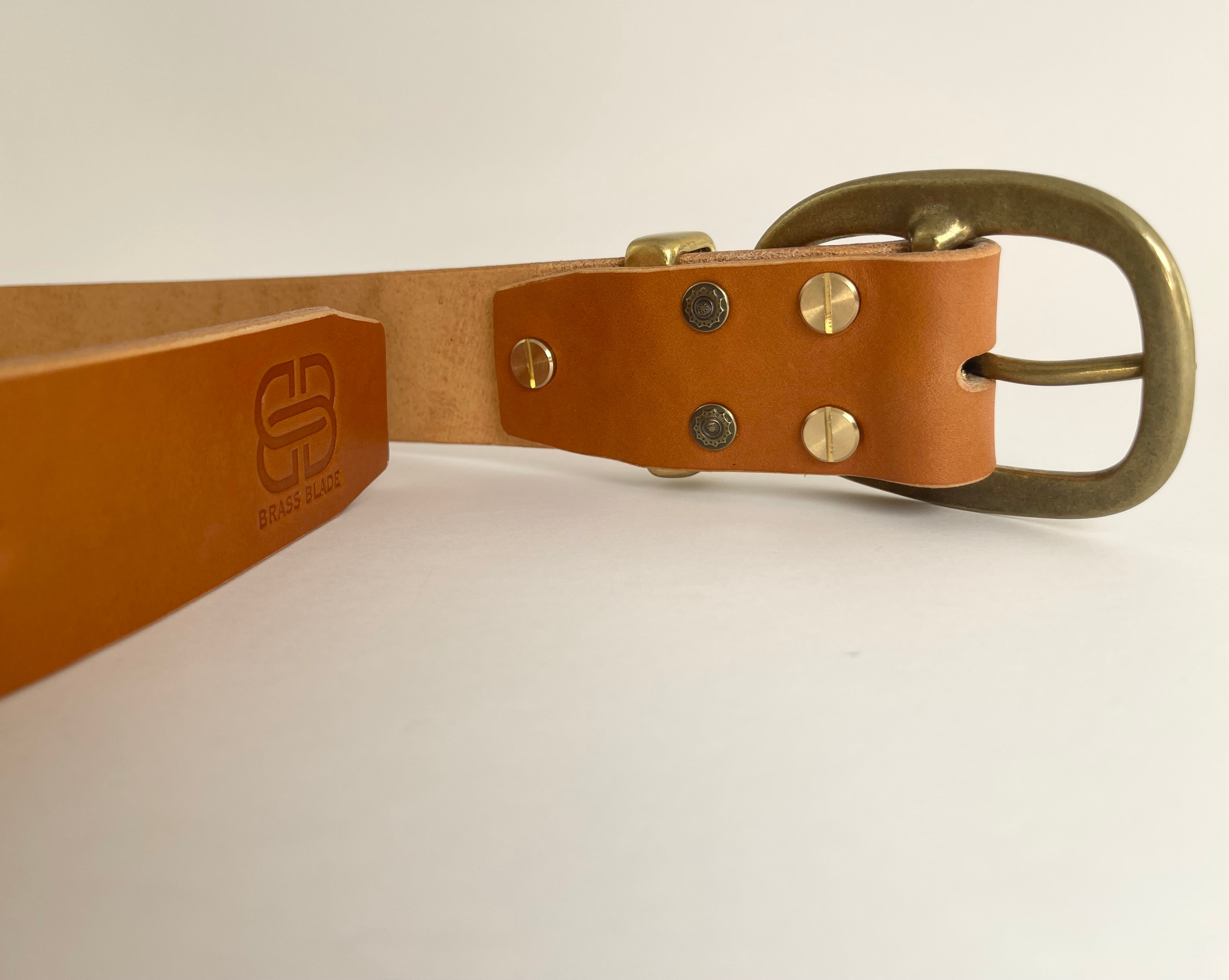 Brown leather belt with brass buckle on a white background