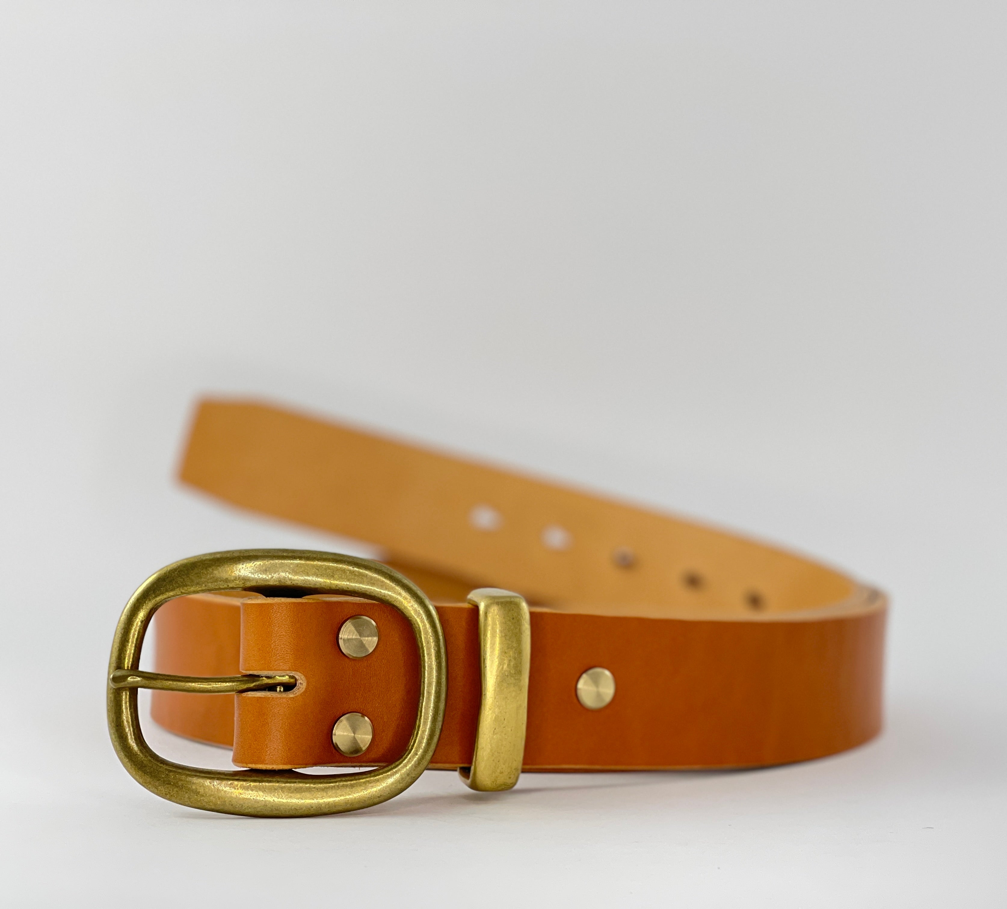 Brown leather belt with a gold buckle on a light gray background