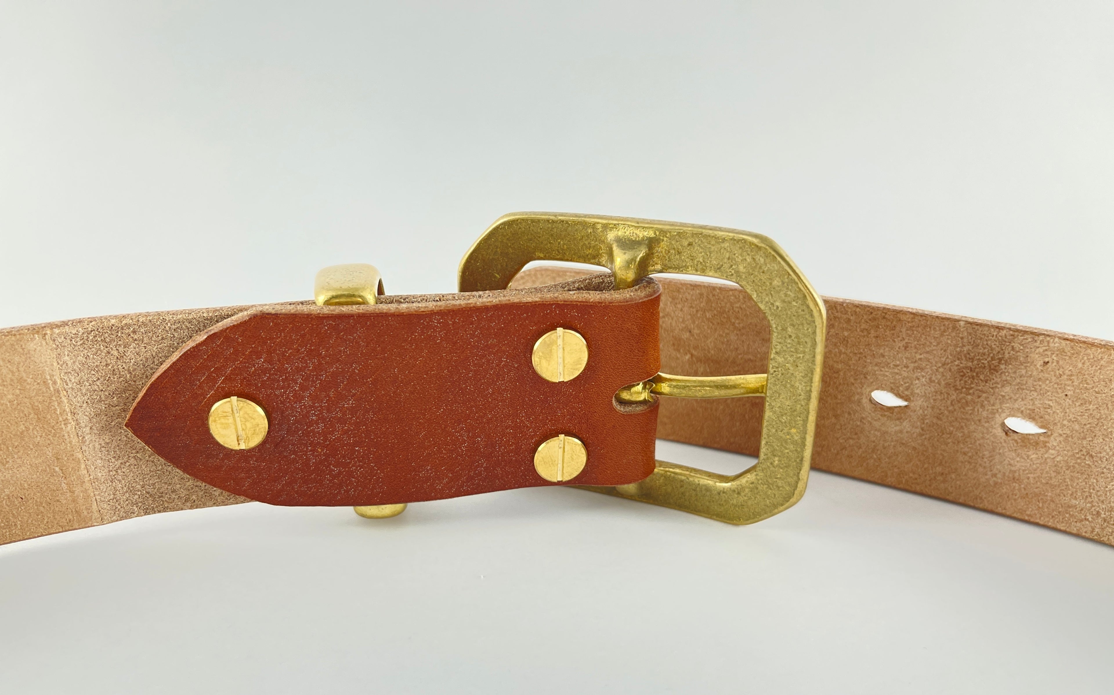 Brown leather belt with gold buckle on a white background