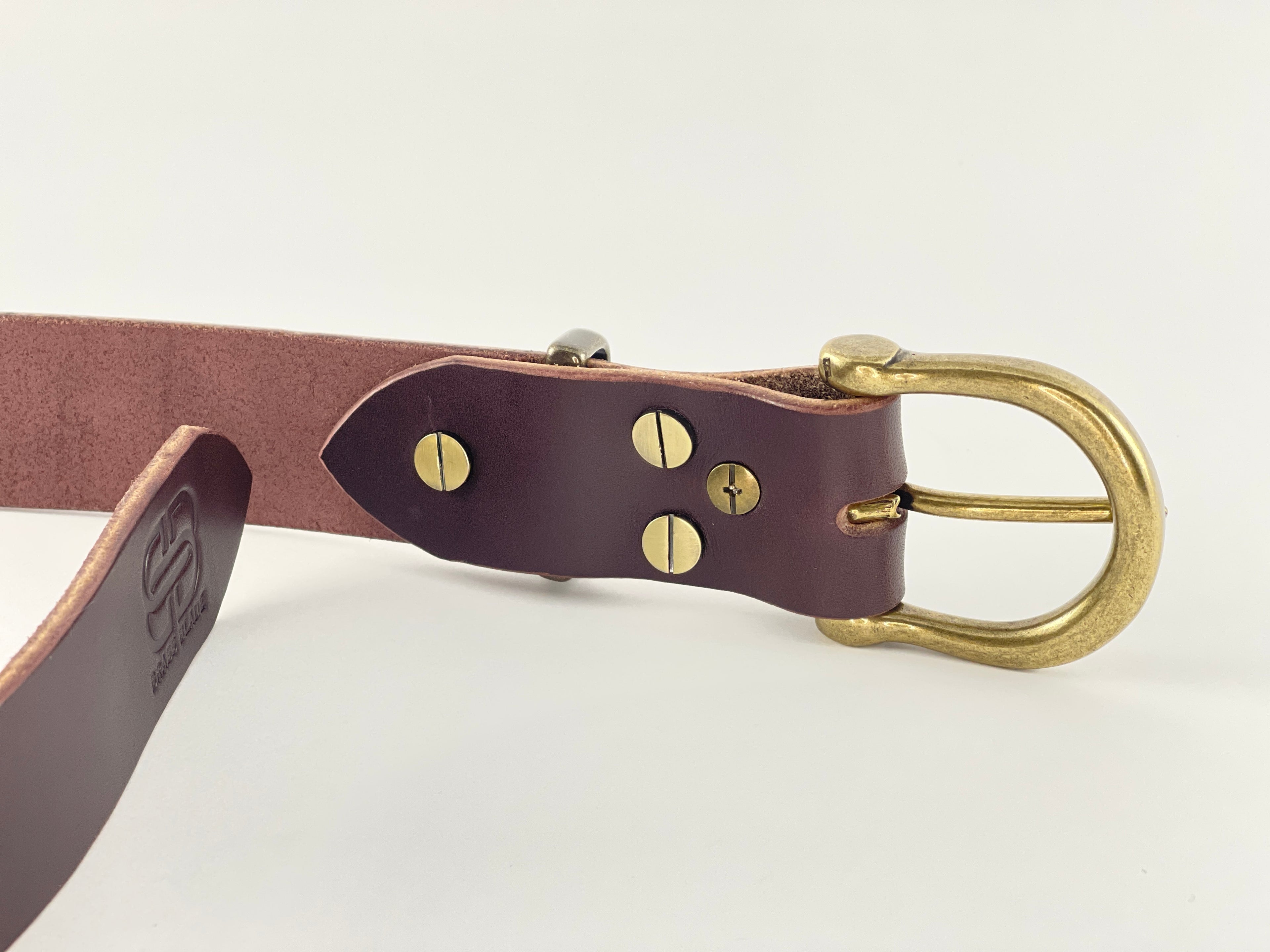 Brown leather belt with brass buckle on a white background