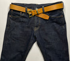 Dark blue jeans with a brown belt on a white background