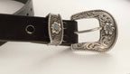 Black belt with a silver buckle on a white background