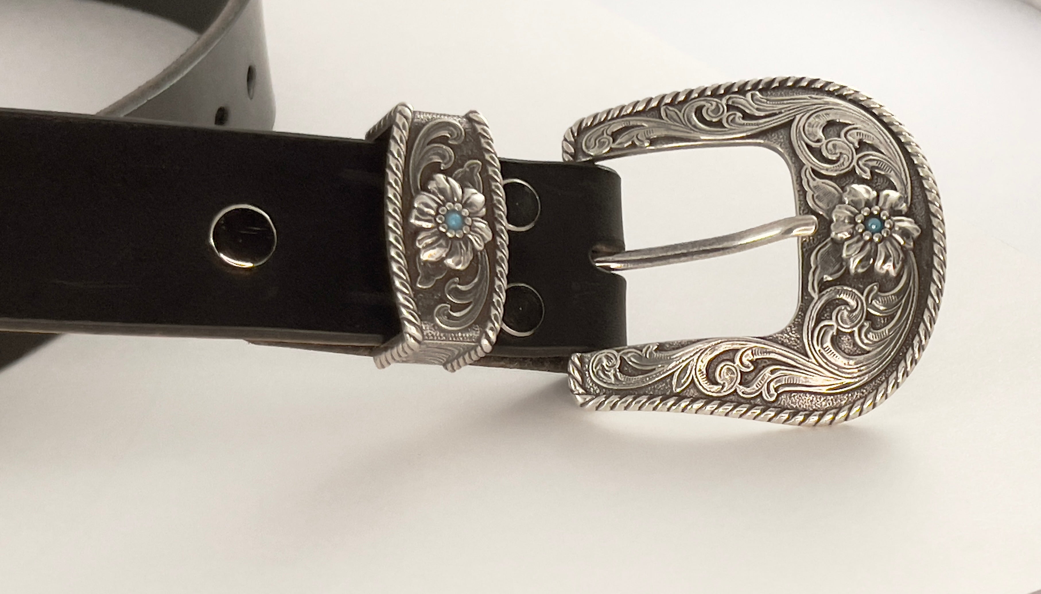 Black belt with a silver buckle on a white background
