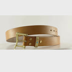 Video of an orange tan belt with a brass quick release buckle on a carousel