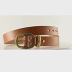Video of a smooth tan leather belt with an oval brass buckle on a carousel