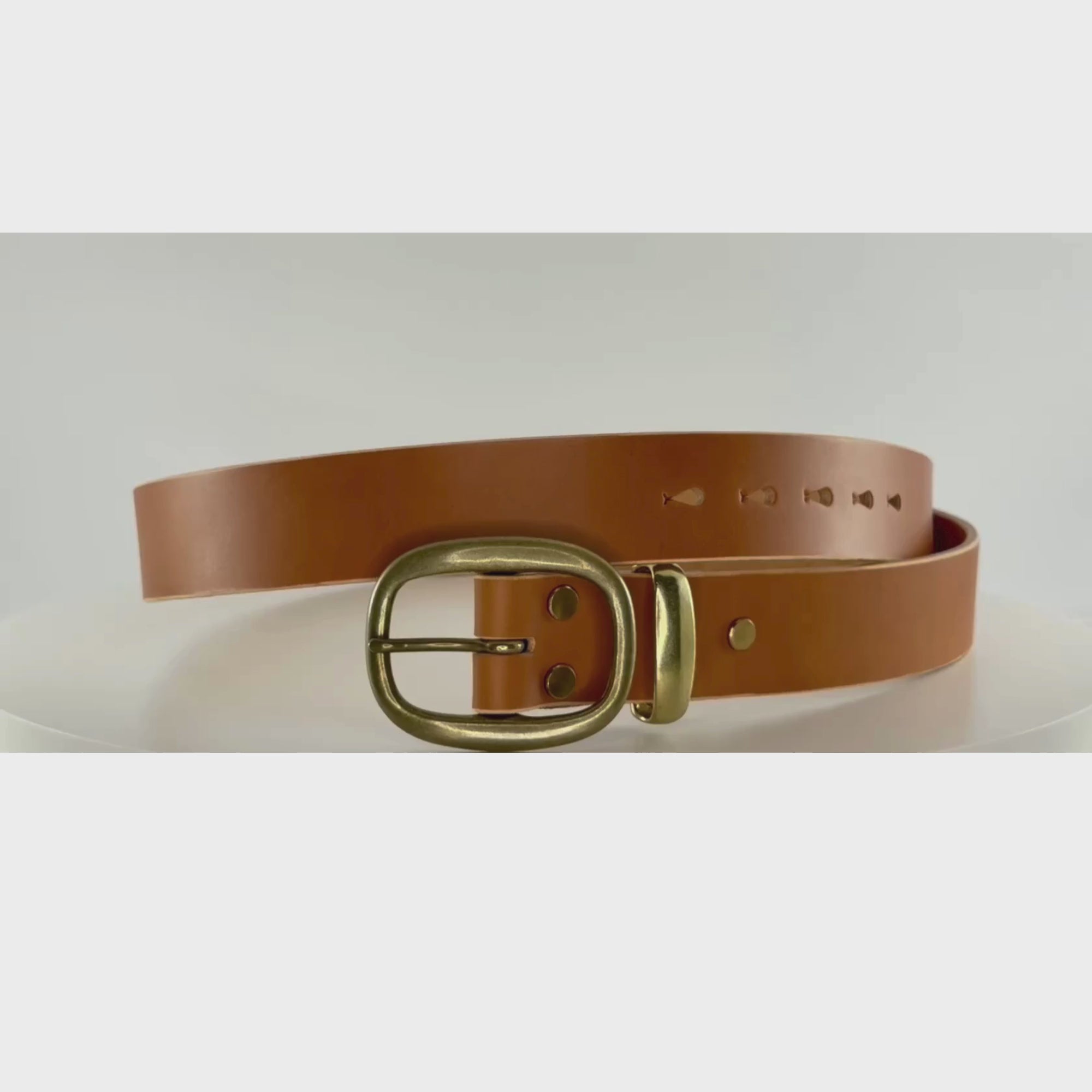 Video of a brown leather belt with brass buckle and keeper revolving on a carousel showing a 360 degree view of the belt